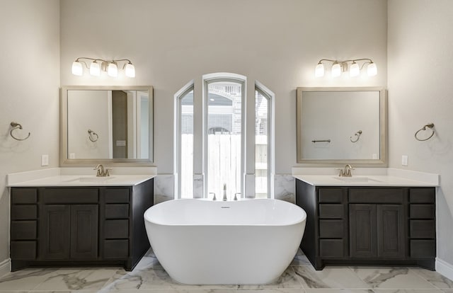12611 Faded Sky Ct, Cypress, TX 77433 - full bathroom featuring marble finish floors, a freestanding tub, and two vanities