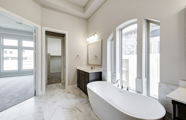 12611 Faded Sky Ct, Cypress, TX 77433 - bathroom featuring vanity, a soaking tub, plenty of natural light, and marble finish floors