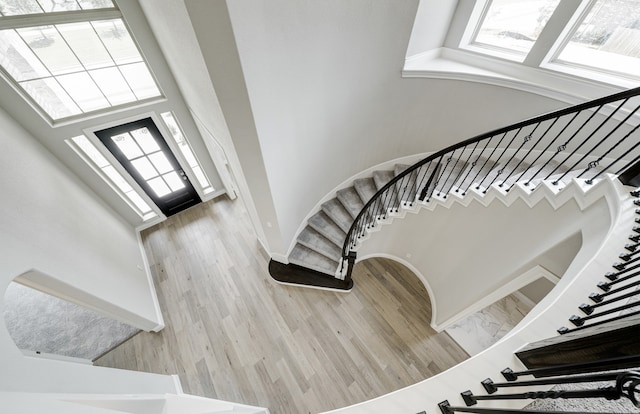 12611 Faded Sky Ct, Cypress, TX 77433 - stairs featuring a towering ceiling and wood finished floors