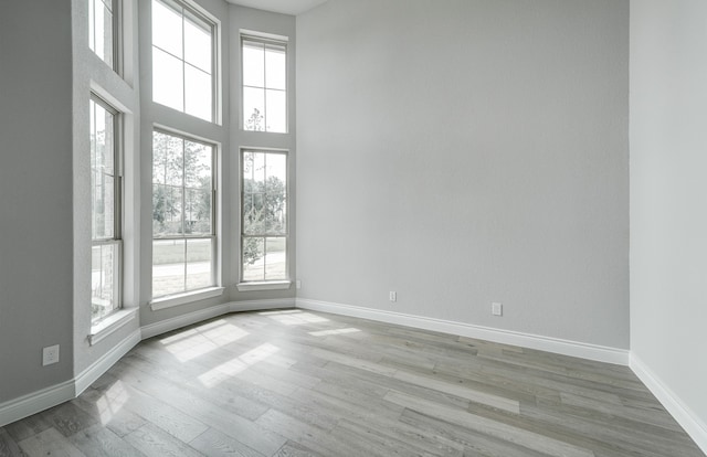 12611 Faded Sky Ct, Cypress, TX 77433 - spare room featuring wood finished floors and a towering ceiling