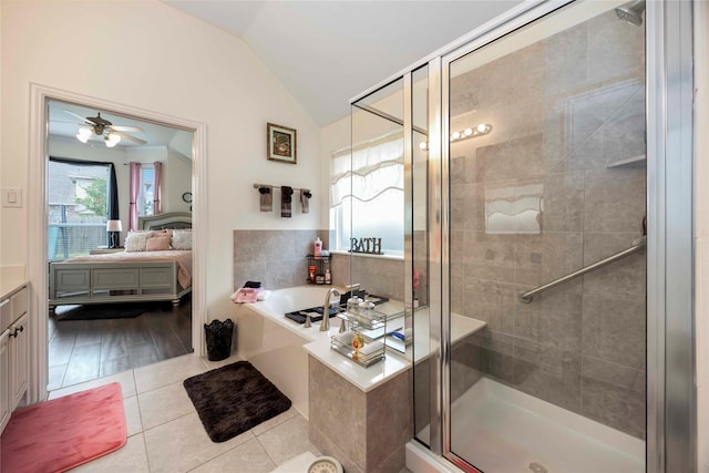 29903 Tallow Grove Ln, Brookshire, TX 77423 - full bathroom with vanity, lofted ceiling, a garden tub, a shower stall, and tile patterned floors