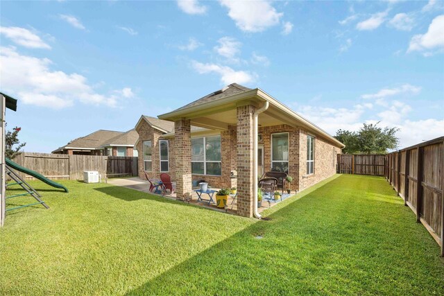 29903 Tallow Grove Ln, Brookshire, TX 77423 - rear view of property featuring brick siding, a patio area, and a fenced backyard