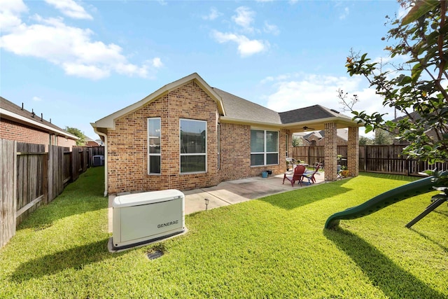 29903 Tallow Grove Ln, Brookshire, TX 77423 - rear view of house featuring brick siding, a ceiling fan, a patio area, roof with shingles, and a fenced backyard