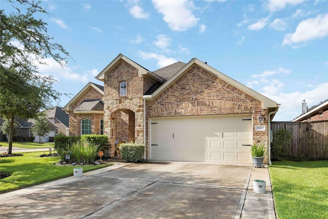 29903 Tallow Grove Ln, Brookshire, TX 77423 - view of front of home featuring stone siding, brick siding, concrete driveway, and an attached garage