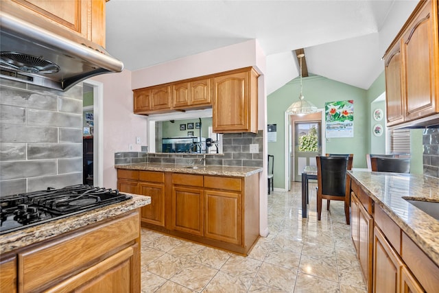 726 Park Knoll Ln, Katy, TX 77450 - kitchen featuring exhaust hood, black gas stovetop, lofted ceiling, backsplash, and brown cabinets
