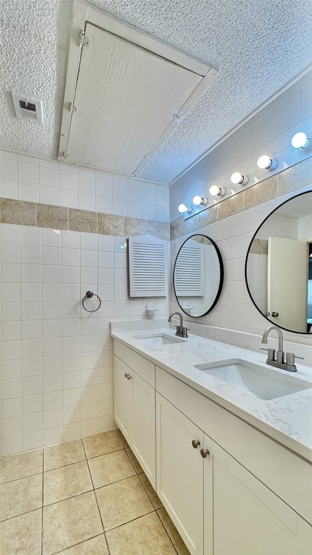 7900 N Stadium Dr Unit 53, Houston, TX 77030 - full bath featuring tile walls, a textured ceiling, double vanity, and tile patterned flooring