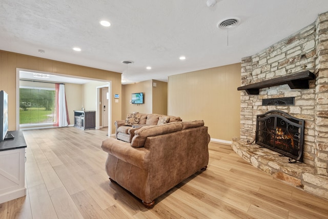 5254 State Highway 146 S, Livingston, TX 77351 - living room with light wood-style flooring, a fireplace, and recessed lighting