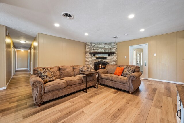 5254 State Highway 146 S, Livingston, TX 77351 - living area featuring light wood-style flooring, a stone fireplace, and recessed lighting