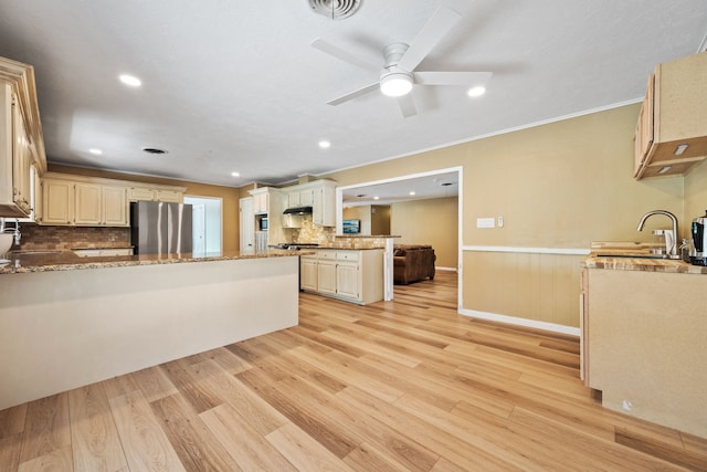 5254 State Highway 146 S, Livingston, TX 77351 - kitchen with freestanding refrigerator, a peninsula, light wood-style floors, wainscoting, and crown molding
