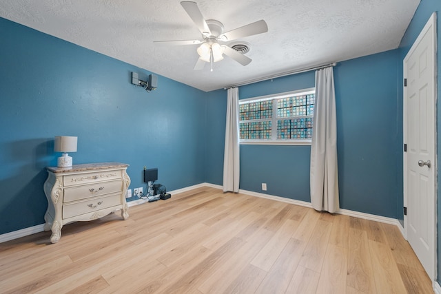 5254 State Highway 146 S, Livingston, TX 77351 - unfurnished bedroom featuring a textured ceiling, wood finished floors, and ceiling fan