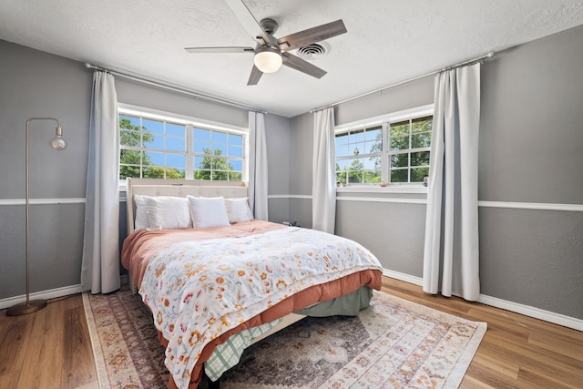 5254 State Highway 146 S, Livingston, TX 77351 - bedroom with wood finished floors, a textured ceiling, and ceiling fan