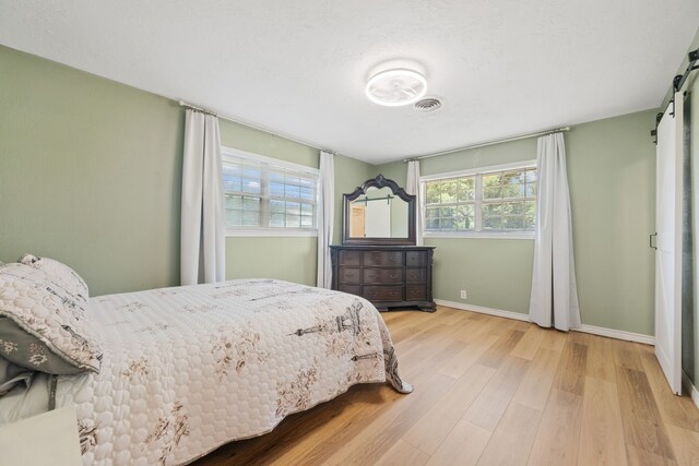 5254 State Highway 146 S, Livingston, TX 77351 - bedroom with wood finished floors and a barn door