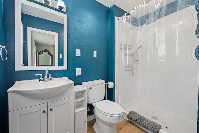 5254 State Highway 146 S, Livingston, TX 77351 - bathroom featuring wood finished floors, vanity, a shower with curtain, and a textured wall