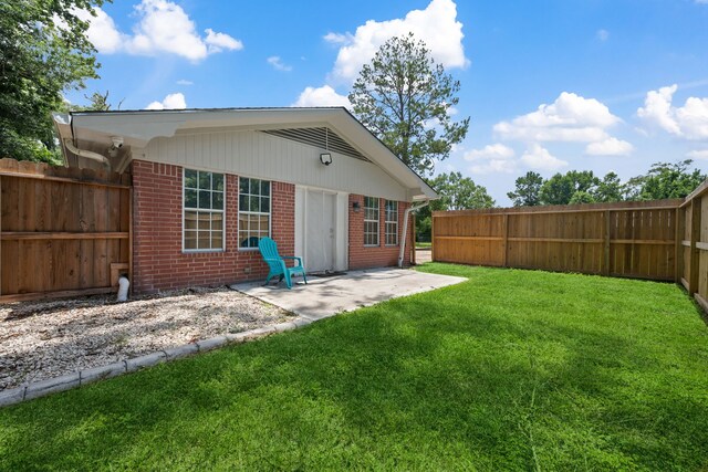 5254 State Highway 146 S, Livingston, TX 77351 - back of property featuring brick siding, a patio area, and a fenced backyard