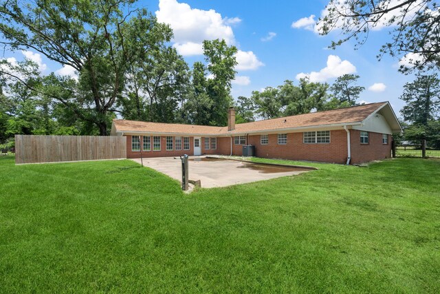 5254 State Highway 146 S, Livingston, TX 77351 - rear view of property featuring brick siding, a patio, and a chimney
