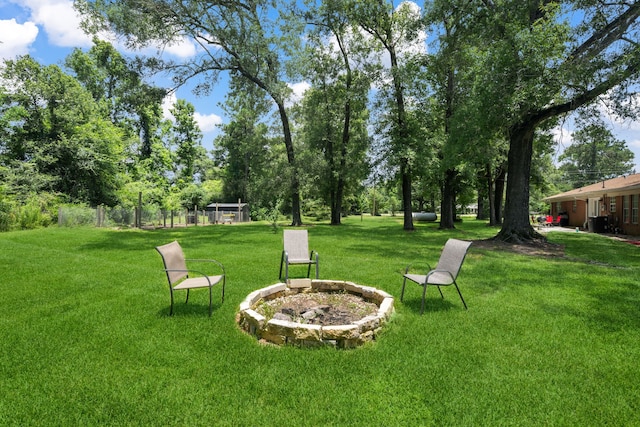 5254 State Highway 146 S, Livingston, TX 77351 - view of grassy yard with a fire pit and view of wooded area