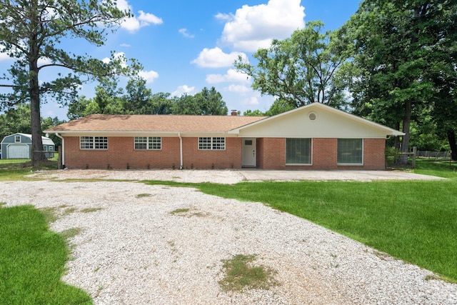 5254 State Highway 146 S, Livingston, TX 77351 - ranch-style home featuring brick siding, gravel driveway, a patio, and a chimney