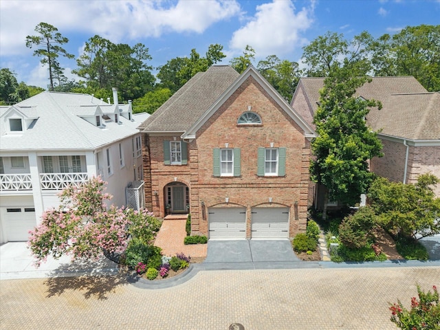 333 Sugarberry Cir, Houston, TX 77024 - view of front of property with a garage, concrete driveway, and brick siding