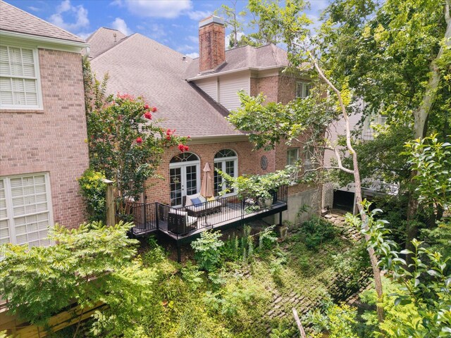 333 Sugarberry Cir, Houston, TX 77024 - rear view of house featuring a chimney, brick siding, a shingled roof, and french doors