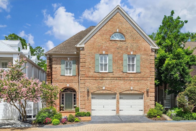 333 Sugarberry Cir, Houston, TX 77024 - traditional-style house with brick siding, concrete driveway, and a garage