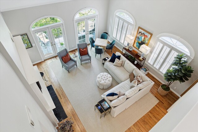 333 Sugarberry Cir, Houston, TX 77024 - living area with french doors, healthy amount of natural light, a high ceiling, and wood finished floors