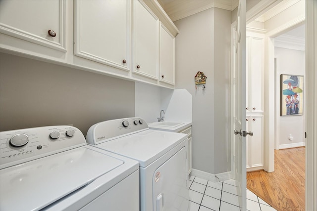 333 Sugarberry Cir, Houston, TX 77024 - laundry room with separate washer and dryer, cabinet space, light tile patterned floors, and crown molding