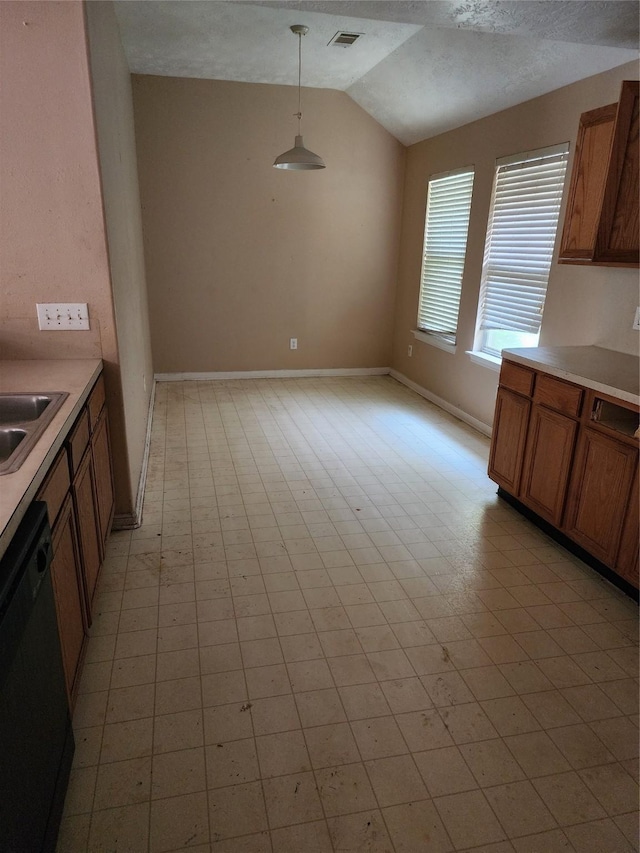 15014 Middle Oaks Blvd, Houston, TX 77082 - kitchen with black dishwasher, lofted ceiling, brown cabinets, light countertops, and pendant lighting