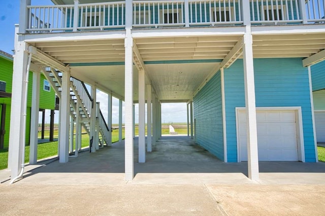 2028 County Road 201, Sargent, TX 77414 - view of parking with an attached garage, driveway, and stairway