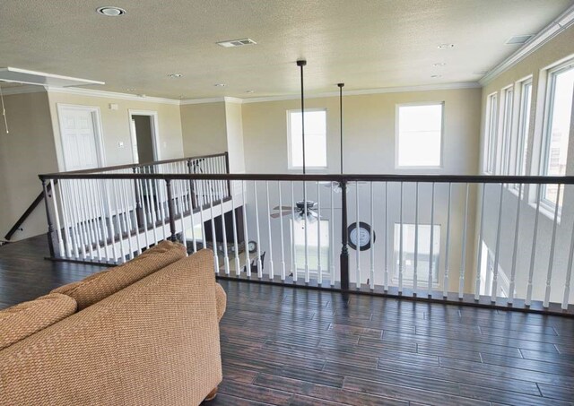 2028 County Road 201, Sargent, TX 77414 - hall featuring wood finished floors, crown molding, and a textured ceiling