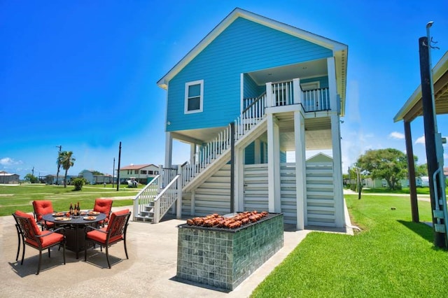 2028 County Road 201, Sargent, TX 77414 - back of property featuring stairway, a patio, a yard, and a fire pit