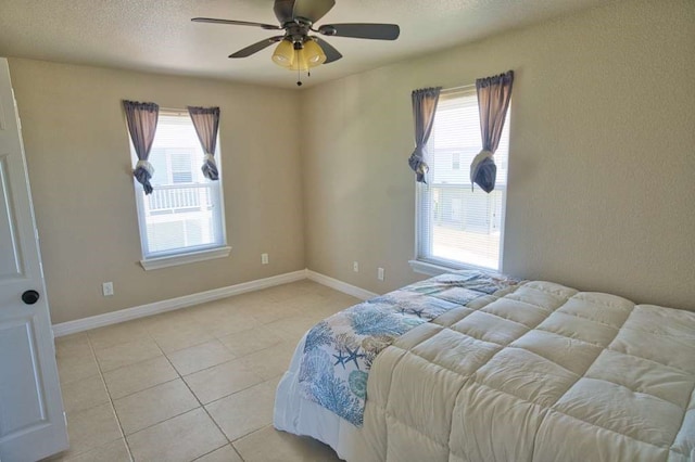 2028 County Road 201, Sargent, TX 77414 - bedroom with multiple windows, light tile patterned flooring, and ceiling fan