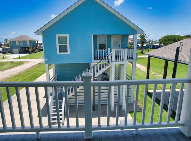 2028 County Road 201, Sargent, TX 77414 - rear view of property featuring stairs, a porch, and a yard