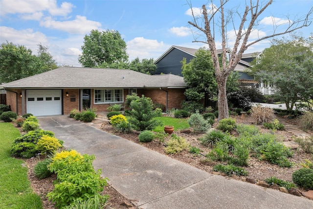 2114 Saxon Dr, Houston, TX 77018 - view of front facade with brick siding, an attached garage, driveway, and a shingled roof