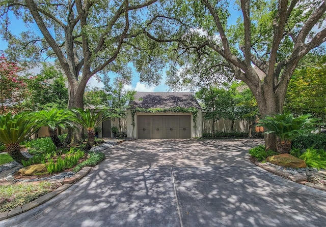 3124 Mid Ln, Houston, TX 77027 - obstructed view of property with driveway, an attached garage, and stucco siding