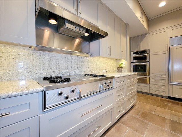 3124 Mid Ln, Houston, TX 77027 - kitchen with under cabinet range hood, stainless steel appliances, tasteful backsplash, a warming drawer, and recessed lighting