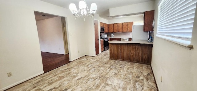 14027 Ambrose St, Houston, TX 77045 - kitchen featuring stainless steel appliances, a chandelier, light countertops, brown cabinetry, and a peninsula