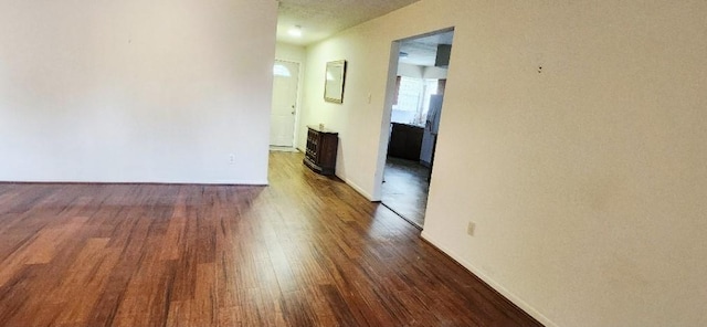 14027 Ambrose St, Houston, TX 77045 - empty room featuring dark wood-style floors and baseboards