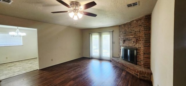 14027 Ambrose St, Houston, TX 77045 - unfurnished living room featuring wood finished floors, a textured ceiling, a fireplace, ceiling fan, and a chandelier