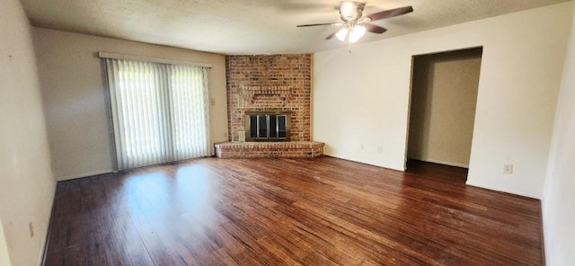 14027 Ambrose St, Houston, TX 77045 - unfurnished living room with a ceiling fan, wood finished floors, and a brick fireplace