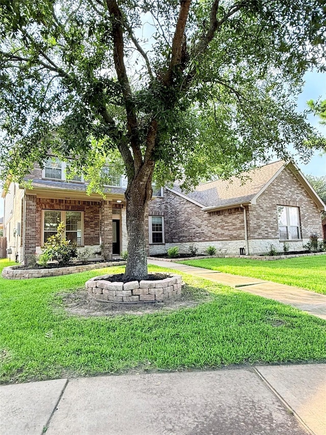 8231 Groveland Hills Dr, Cypress, TX 77433 - view of front facade featuring a front yard, brick siding, and roof with shingles
