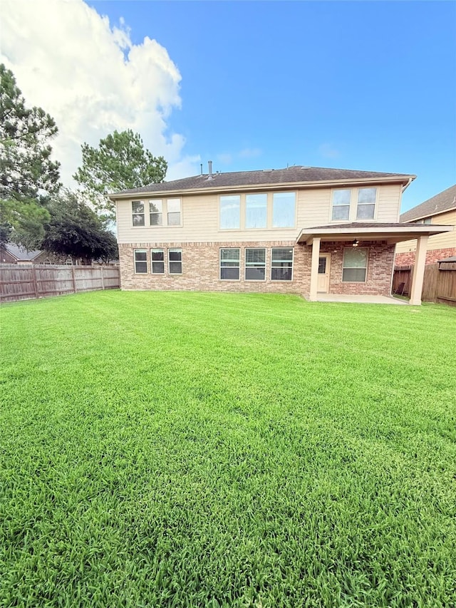 8231 Groveland Hills Dr, Cypress, TX 77433 - back of house with a fenced backyard and a patio area
