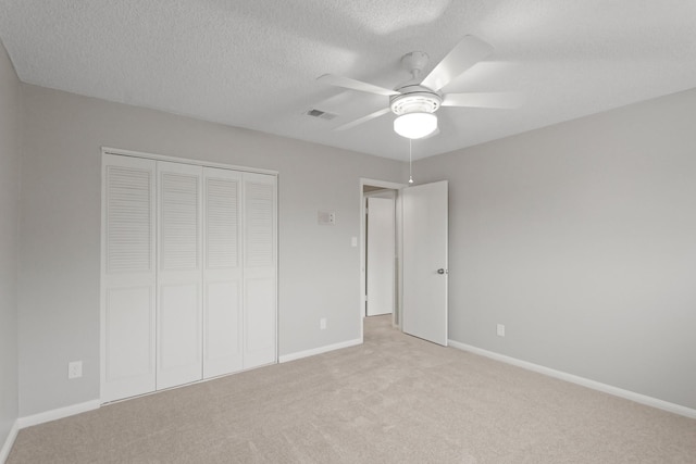 2212 Shadowdale Dr Unit 358, Houston, TX 77043 - unfurnished bedroom featuring a closet, light carpet, a textured ceiling, and ceiling fan