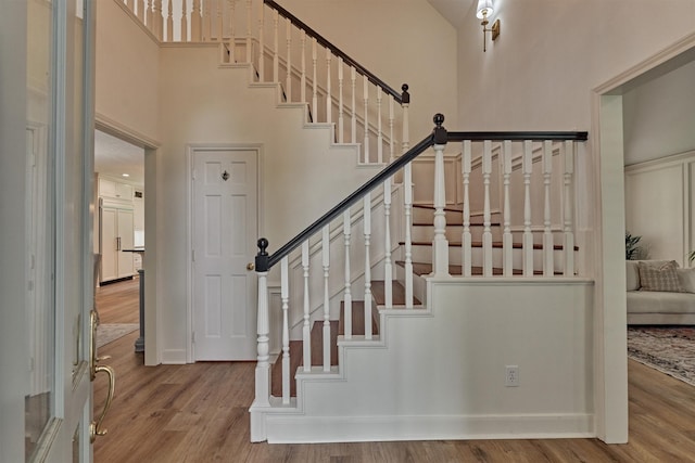 23119 Hampton Forest Ln, Spring, TX 77389 - stairway featuring a high ceiling and wood finished floors