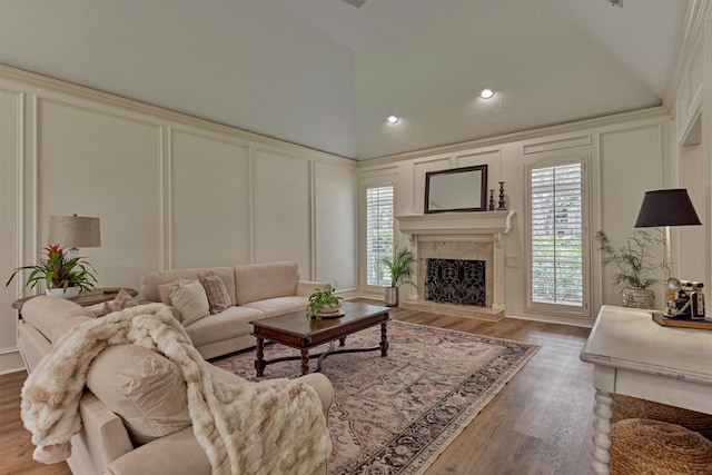 23119 Hampton Forest Ln, Spring, TX 77389 - living area featuring a decorative wall, a high end fireplace, wood finished floors, high vaulted ceiling, and recessed lighting