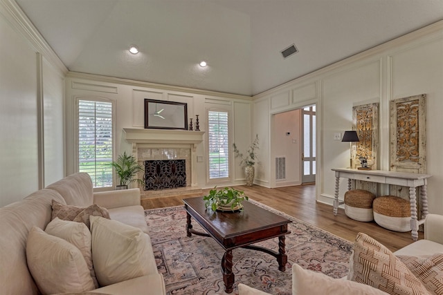 23119 Hampton Forest Ln, Spring, TX 77389 - living area with a decorative wall, a fireplace, high vaulted ceiling, and wood finished floors