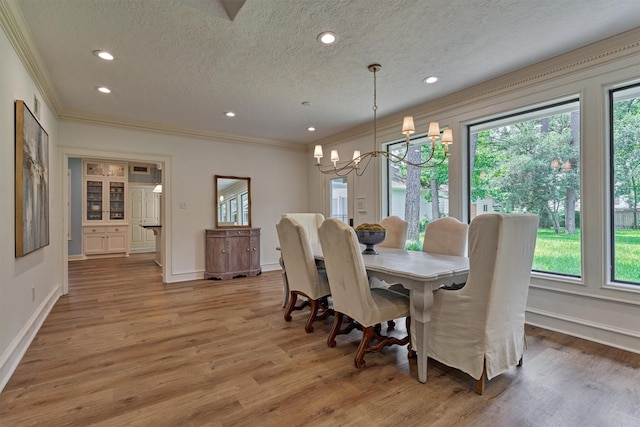 23119 Hampton Forest Ln, Spring, TX 77389 - dining area featuring crown molding, a chandelier, light wood-style floors, a textured ceiling, and recessed lighting