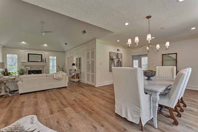 23119 Hampton Forest Ln, Spring, TX 77389 - dining area with a chandelier, ornamental molding, ceiling fan, light wood finished floors, and a textured ceiling