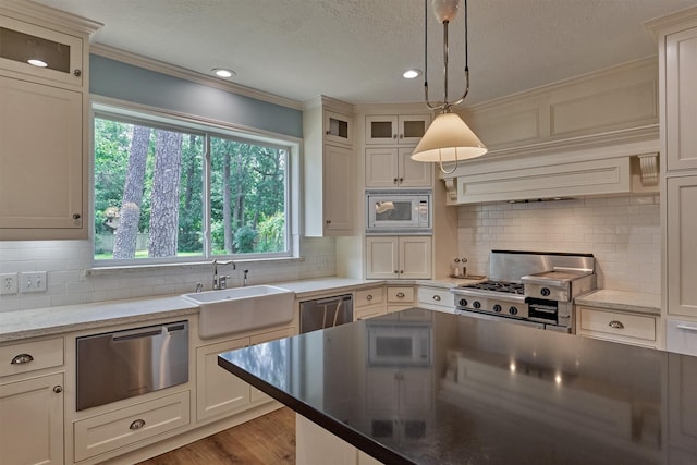 23119 Hampton Forest Ln, Spring, TX 77389 - kitchen with range, white microwave, dishwasher, a textured ceiling, and crown molding