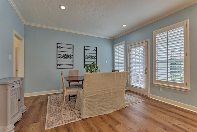 23119 Hampton Forest Ln, Spring, TX 77389 - dining room with crown molding, wood finished floors, a textured ceiling, and recessed lighting