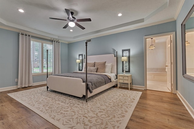 23119 Hampton Forest Ln, Spring, TX 77389 - bedroom featuring wood finished floors, ornamental molding, recessed lighting, ensuite bathroom, and a raised ceiling